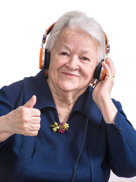 Old woman listening to music in headphones - Fotografie, Obrázek