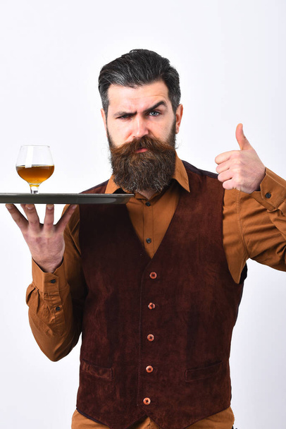 Waiter with brandy or scotch on tray. Alcoholic beverage concept. - Foto, Imagen