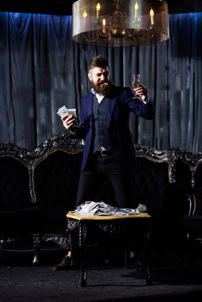 Minded rich man hold glass with brandy - Фото, зображення