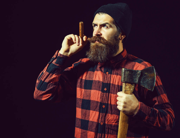 Man with axe and cigar on black background - Zdjęcie, obraz