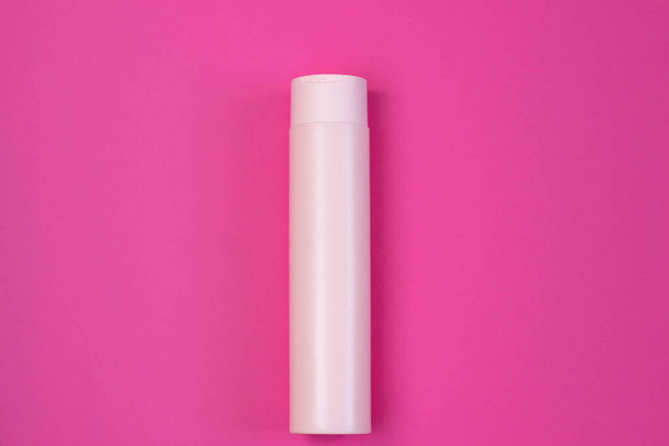 Cosmetic pink bottle with serum, gel, face cream. Skin cosmetics, minimalism. The concept of salon procedures. - Фото, зображення