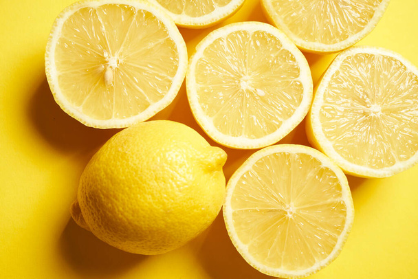 fresh lemons on a yellow minimalistic background - 写真・画像