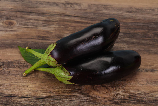 Few Ripe tasty Eggplant over wooden background - Zdjęcie, obraz