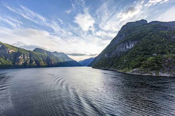 Impression from cruise ship on the way through Geiranger fjord in Norway at sunrise - Φωτογραφία, εικόνα
