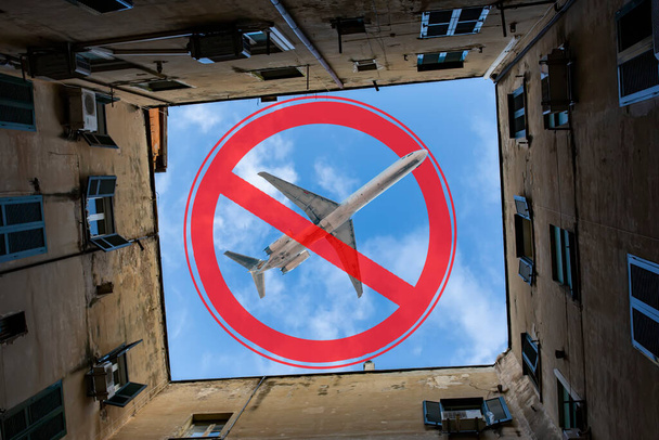El signo de la prohibición y un avión de juguete en miniatura. Prohibición de vuelos de aeronaves civiles. Zona prohibida. Detener símbolo. Prohibición de construcción de aeropuertos. Avión. Vuelos nocturnos. Ley. Prohibición - Foto, imagen