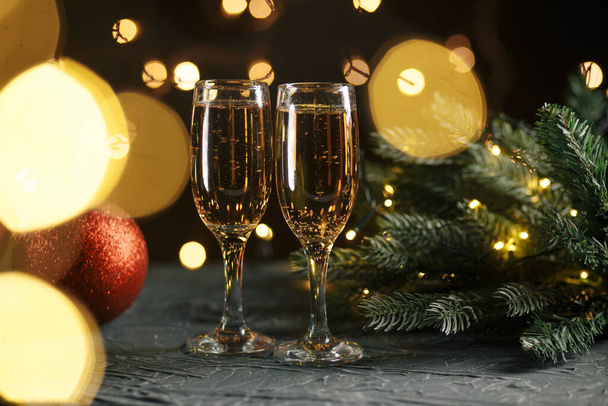 Ribbon, baubles and wine against Christmas lights - Foto, Imagem