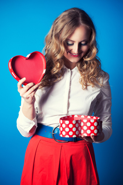 Woman holding heart-shaped box - Фото, изображение
