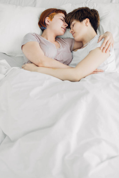 pleasant girls embracing each other in the bedroom - Фото, зображення