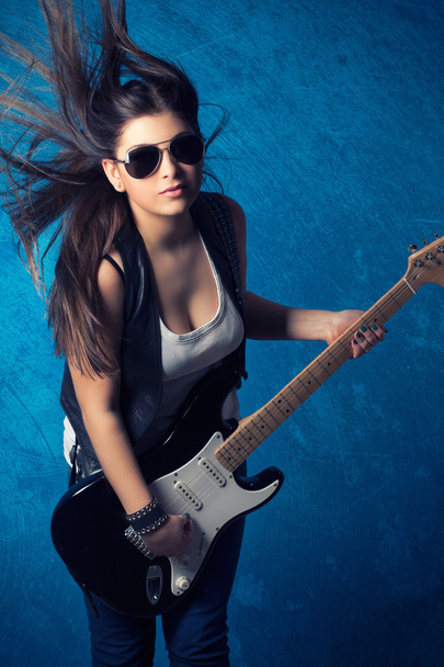 Beautiful young woman with guitar - Fotó, kép