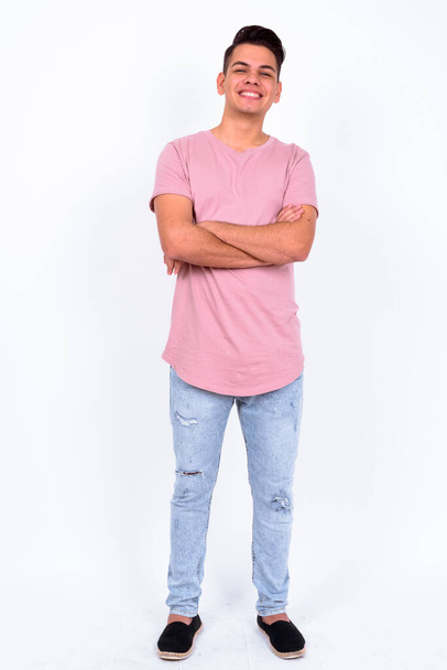 Studio shot of young handsome multi ethnic man against white background - Foto, afbeelding