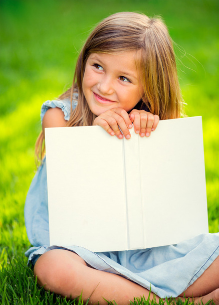 Adorable little girl reading book - 写真・画像