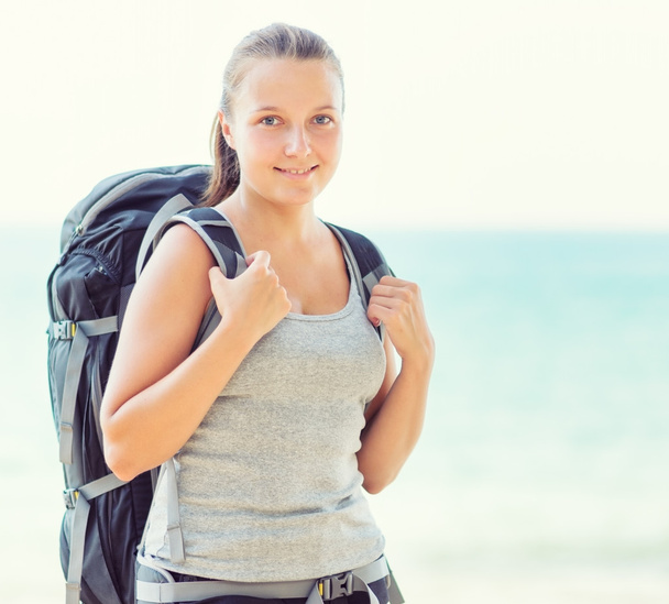 Young female backpacker on a beach - Φωτογραφία, εικόνα