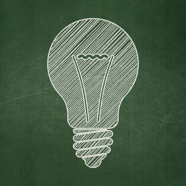 Business concept: Light Bulb on chalkboard background - 写真・画像