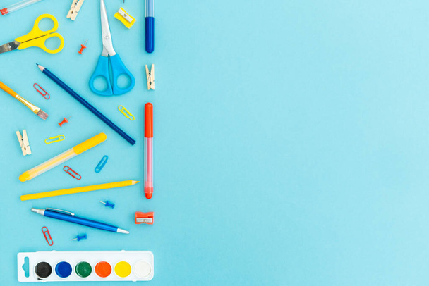 Office and school supplies on blue background. Copy space. Back to school concept. - Zdjęcie, obraz