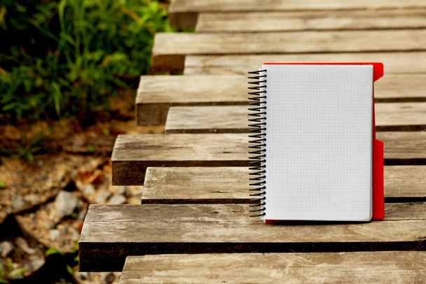 Notebook, open Notepad on a spiral on a dark wood textured background, copy space. - 写真・画像