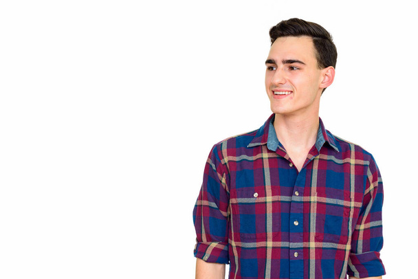 Studio shot of young handsome hipster man isolated against white background - Фото, изображение