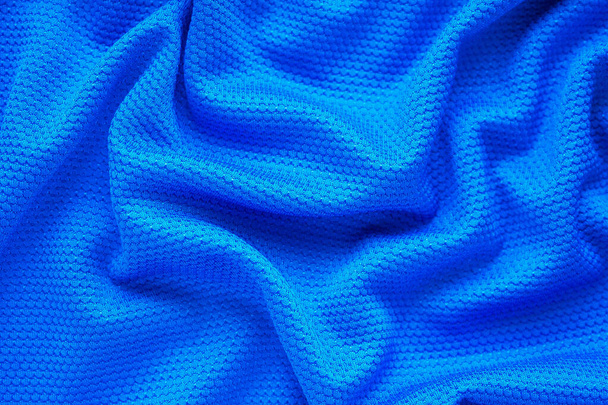 Blue football jersey clothing fabric texture sports wear background, close up top view - Photo, Image
