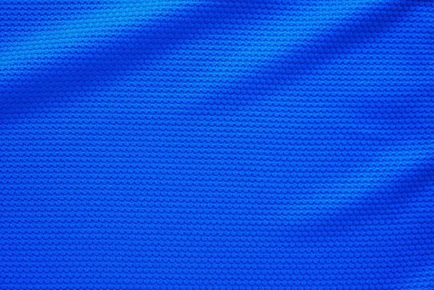 Blue football jersey clothing fabric texture sports wear background, close up top view - Photo, Image