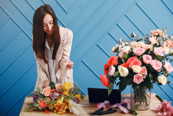 Frorist makes a beautiful bouquet in a studio - Zdjęcie, obraz
