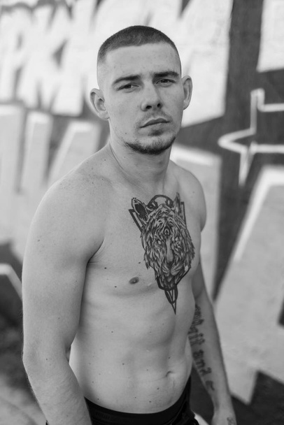 Male bully with a naked torso. Black and white photo - Φωτογραφία, εικόνα
