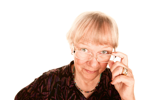 Senior woman looking over her glasses - Foto, Imagem