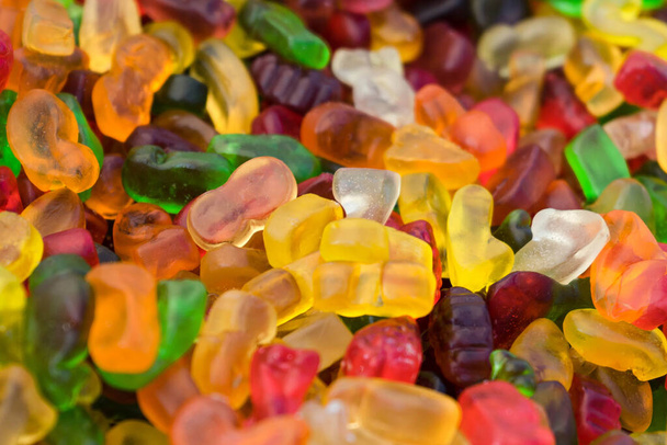 A high angle closeup shot of hundreds of colorful gummy bears - 写真・画像