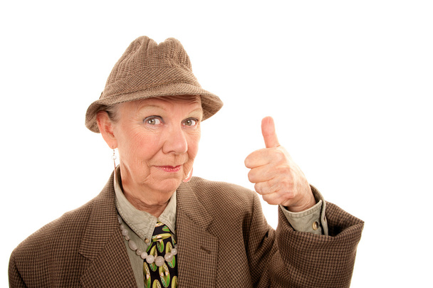 Senior woman in drag giving thumbs up gesture - 写真・画像