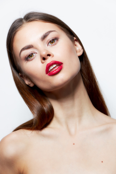 Brunette Bare shoulders red lips head tilted to one side natural look light  - Photo, image