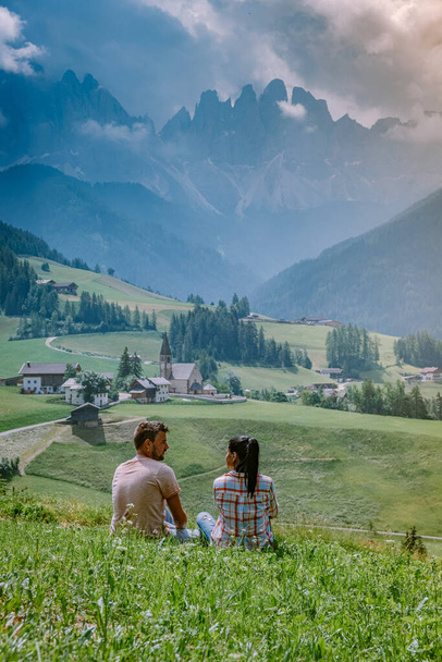 couple on vacation in the Dolomites Italy, Santa Magdalena Village in Dolomites area Italy Val di Funes - 写真・画像