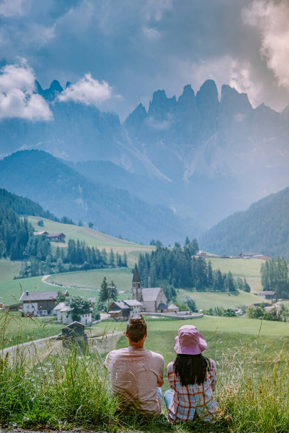 couple on vacation in the Dolomites Italy, Santa Magdalena Village in Dolomites area Italy Val di Funes - 写真・画像