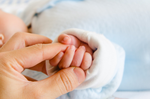 Holding hands of the baby and her father - Photo, Image