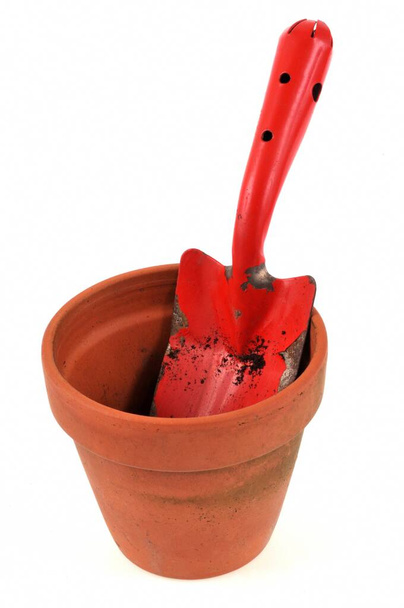 Flowerpot with a dibble close-up on white background - Photo, Image