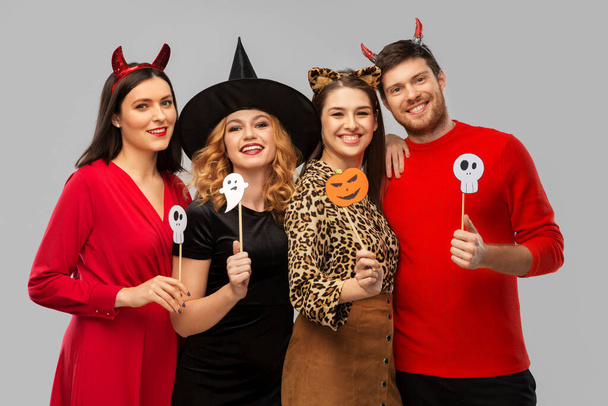 friends in halloween costumes with party props - Foto, immagini