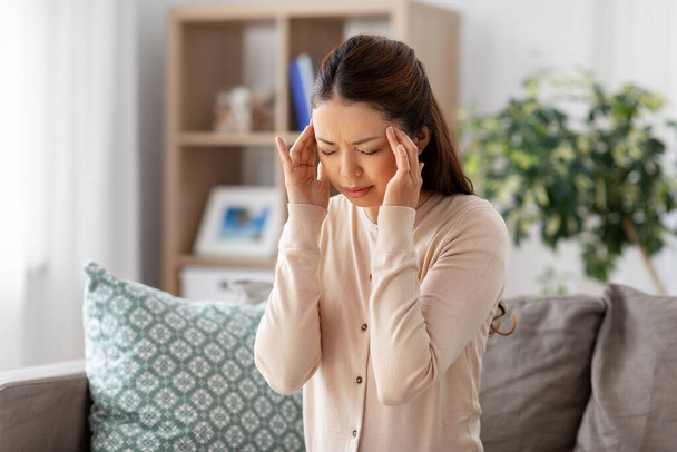sick asian woman having headache at home - Photo, Image