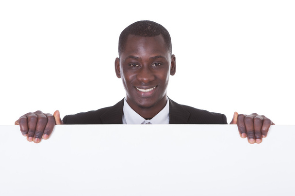 African Businessman Holding Placard - Foto, afbeelding