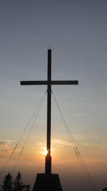 Summit cross on top of the mountain, in the european alps, at sunset - Photo, Image