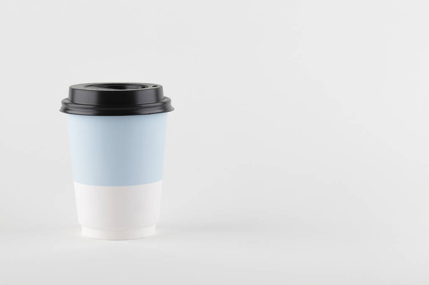 візьміть паперову чашку для кави або чаю на білому тлі. копіювання простору. концепція мінімальної кави
. - Фото, зображення