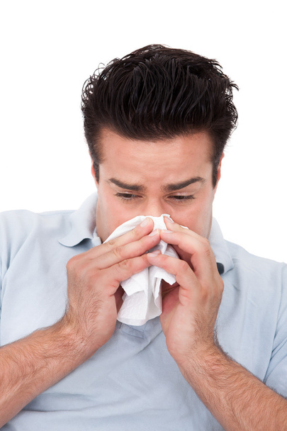 Man Sneezing Into A Tissue - Foto, afbeelding