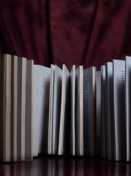 Books on a maroon background - Foto, afbeelding
