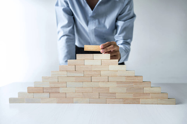 Risk To Make Business Growth Concept With Wooden Blocks, hand of business woman has piling up and stacking a wooden block, Alternative risk concept, plan and strategy in business. - Fotografie, Obrázek