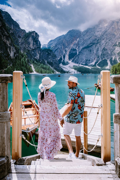 couple visit the famous lake Lago Di Braies Italy, Pragser Wildsee in South Tyrol, Beautiful lake in the italian alps, Lago di Braies - Photo, Image