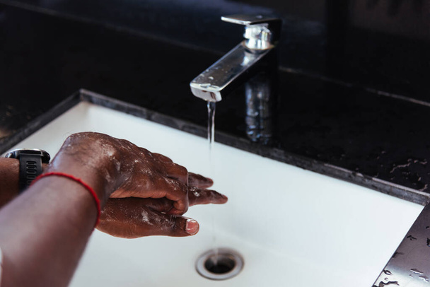 Closeup washing black man hands rubbing with soap and water in sinks to prevent outbreak coronavirus hygiene to stop spreading virus, hygiene for quarantine cleaning COVID-19 concept - Foto, immagini