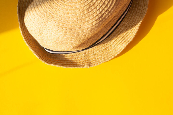 straw hat on a yellow background.Flat lay. Color concept of travel or vacation holidays. - Foto, immagini
