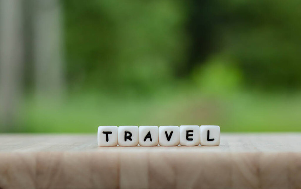 Dice the word "TRAVEL" Text dice cube concept / Letter dices alphabet on wooden background. Block of alphabet studded on the floor. coppy space. - Photo, Image