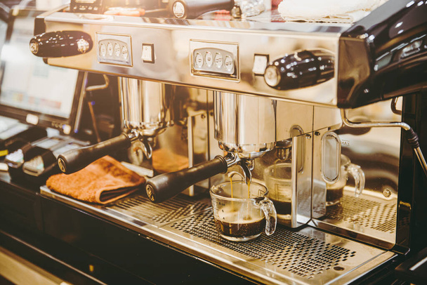 closeup espresso machine making fresh coffee at coffee shop vintage color tone - 写真・画像