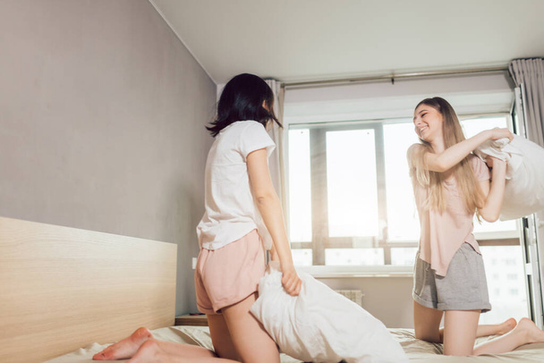 two positive sisters having fun in the bedroom - Photo, image