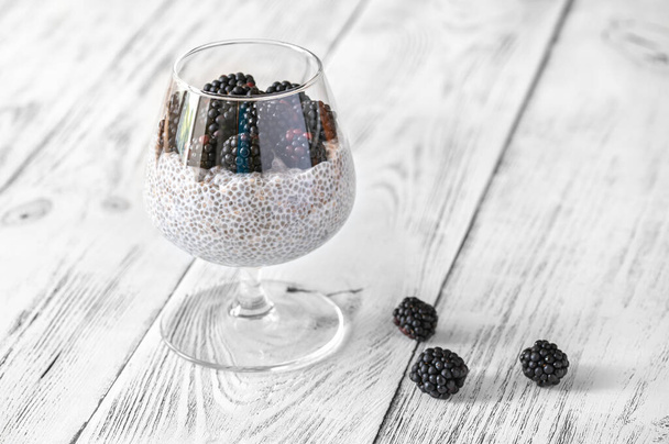 Glass of coconut milk chia seed pudding with blackberries - Fotoğraf, Görsel