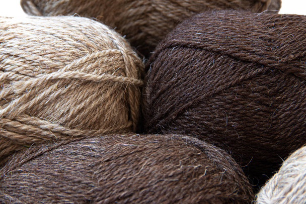 Wool yarns for knitting. Wool thread for knitting. Own hand. Knitting and needlework. Yarns for a scarf, sweater, and socks. Balls of yarn. Article about earning money at home with your hands. Article about knitting. Leisure for pensioners - Photo, Image