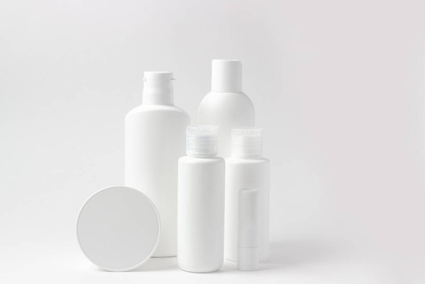 Set of white cosmetic bottles and jars on white background with place to add text - Photo, image