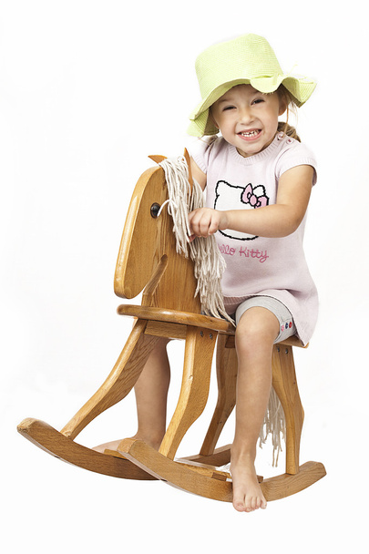 Little girl and rocking horse - Fotografie, Obrázek